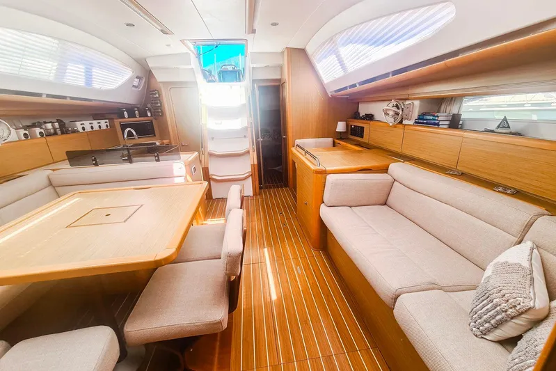  Yacht Photos Pics Luxurious interior of 2009 Jeanneau Sun Odyssey 50 DS yacht with elegant wood finish.