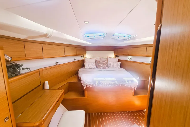  Yacht Photos Pics Luxurious cabin interior of 2009 Jeanneau Sun Odyssey 50 DS yacht with skylights and wooden finish.