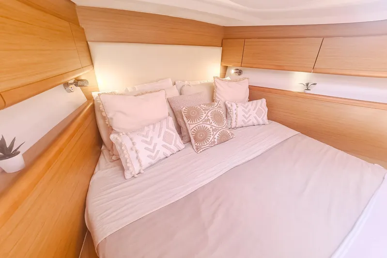  Yacht Photos Pics Luxurious cabin interior of 2009 Jeanneau Sun Odyssey 50 DS with elegant bedding and wood finish.