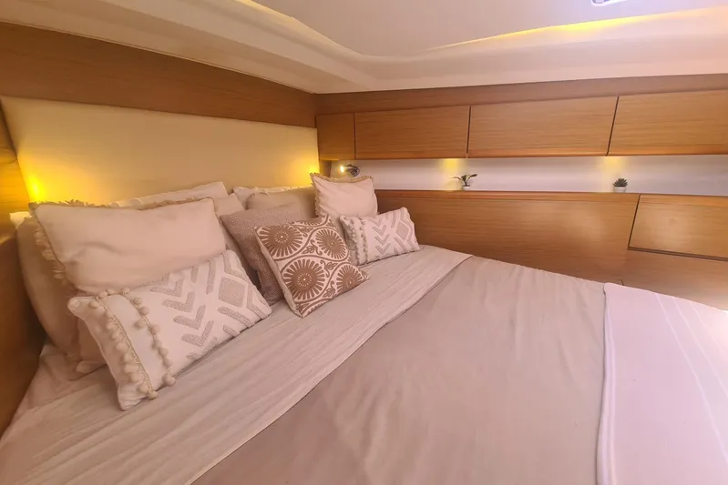  Yacht Photos Pics Luxurious cabin interior of 2009 Jeanneau Sun Odyssey 50 DS with elegant bedding and ambient lighting.