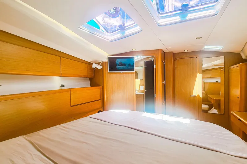  Yacht Photos Pics Luxurious interior of 2009 Jeanneau Sun Odyssey 50 DS yacht cabin with wood finish.