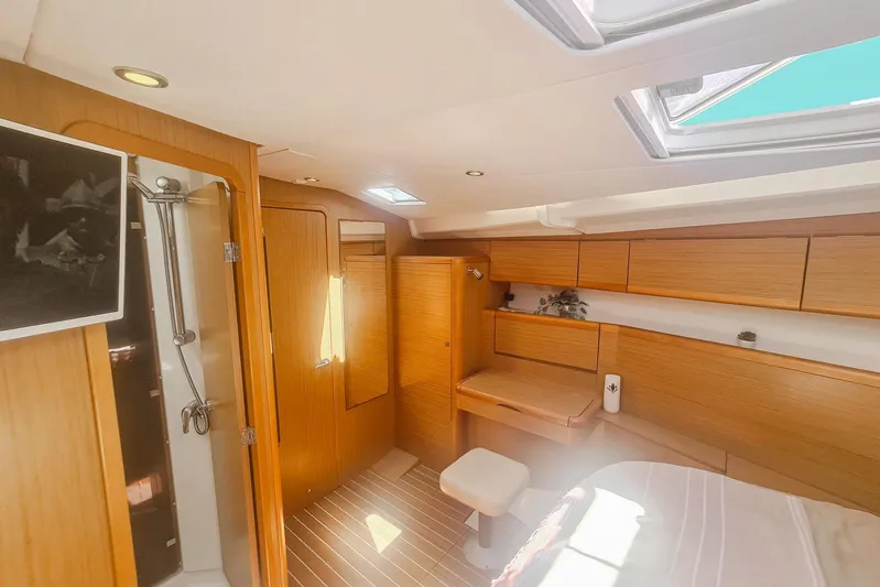  Yacht Photos Pics Luxurious interior of 2009 Jeanneau Sun Odyssey 50 DS yacht with wood finish and skylight.