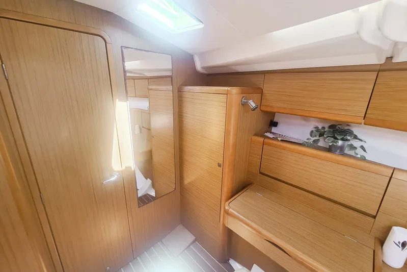  Yacht Photos Pics Interior of 2009 Jeanneau Sun Odyssey 50 DS yacht with wooden cabinetry and mirror.