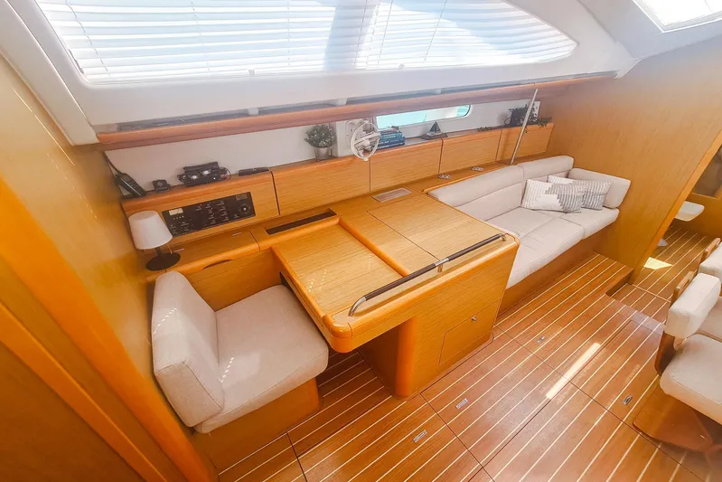  Yacht Photos Pics Interior of 2009 Jeanneau Sun Odyssey 50 DS yacht with wooden finish and cozy seating.