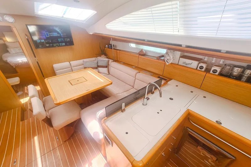  Yacht Photos Pics Interior of 2009 Jeanneau Sun Odyssey 50 DS yacht with modern kitchen and seating area.