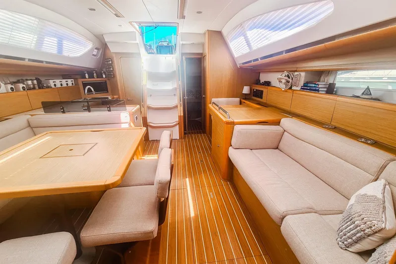  Yacht Photos Pics Luxurious interior of 2009 Jeanneau Sun Odyssey 50 DS yacht with elegant wood finish.