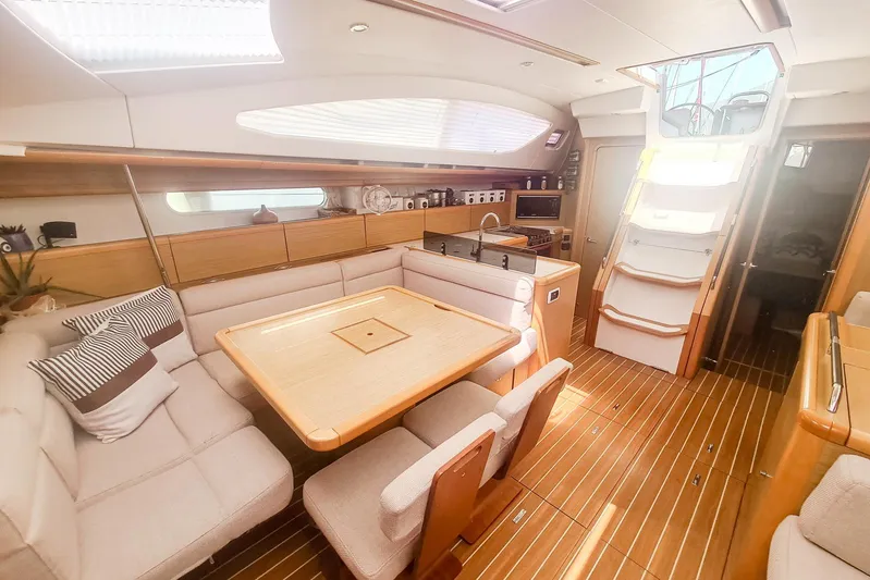  Yacht Photos Pics Interior of 2009 Jeanneau Sun Odyssey 50 DS yacht, featuring elegant wood finishes and spacious seating.