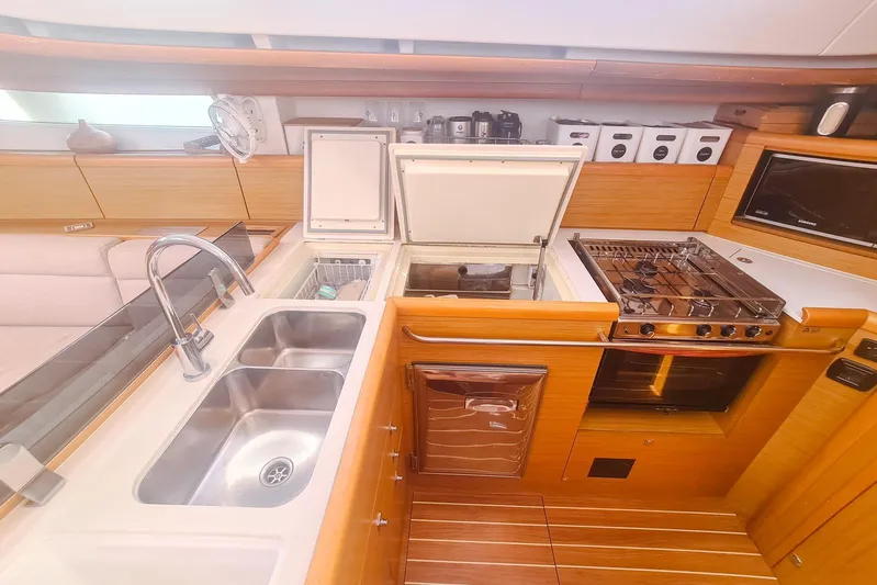  Yacht Photos Pics Luxurious kitchen in 2009 Jeanneau Sun Odyssey 50 DS yacht with modern amenities.