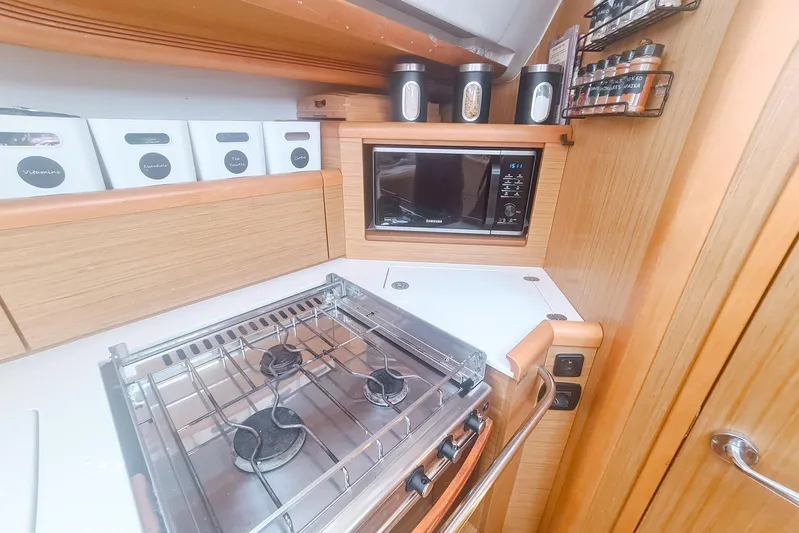  Yacht Photos Pics Galley kitchen in 2009 Jeanneau Sun Odyssey 50 DS yacht with stove and microwave.