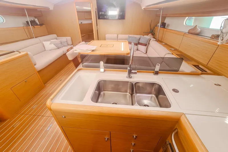  Yacht Photos Pics Interior of 2009 Jeanneau Sun Odyssey 50 DS yacht with modern kitchen and seating area.