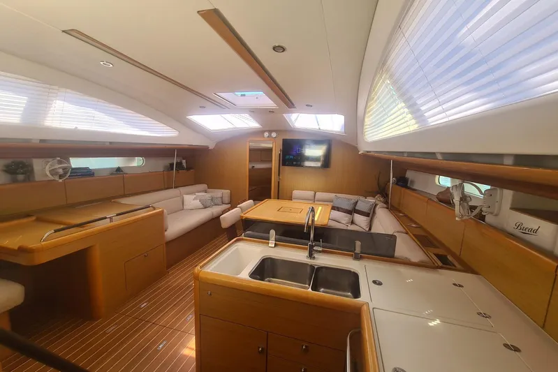  Yacht Photos Pics Interior of 2009 Jeanneau Sun Odyssey 50 DS yacht, featuring spacious seating and modern kitchen.