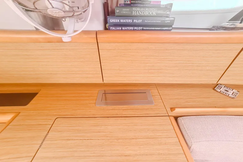  Yacht Photos Pics Interior of 2009 Jeanneau Sun Odyssey 50 DS with books and wooden cabinetry.