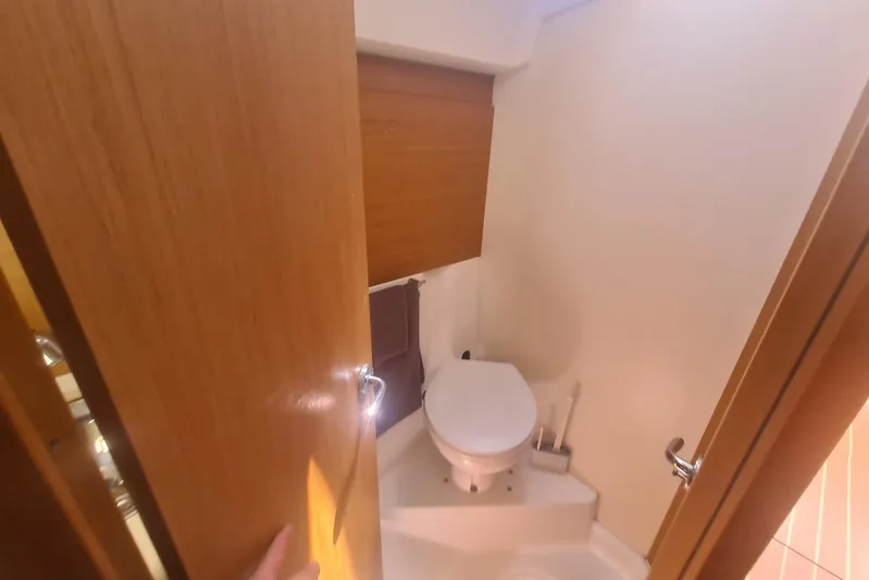  Yacht Photos Pics Bathroom interior of 2009 Jeanneau Sun Odyssey 50 DS yacht, featuring a compact toilet.