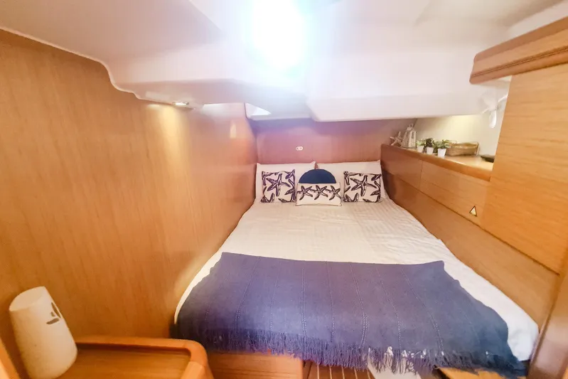  Yacht Photos Pics Cozy cabin interior of 2009 Jeanneau Sun Odyssey 50 DS with nautical decor.