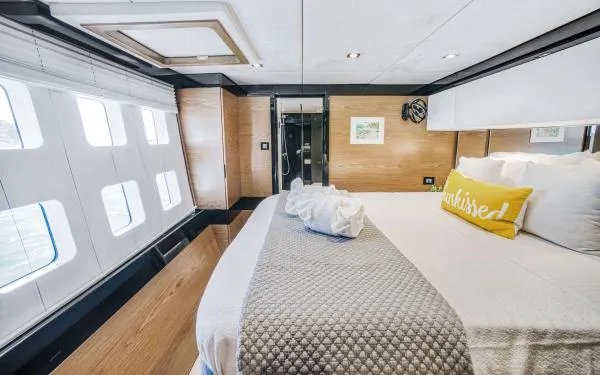 Euphoria Yacht Photos Pics Luxurious Sunreef 60 LOFT 2016 yacht bedroom with modern decor and large windows.