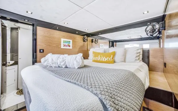 Euphoria Yacht Photos Pics Luxurious Sunreef 60 LOFT 2016 yacht bedroom with modern decor and cozy bedding.
