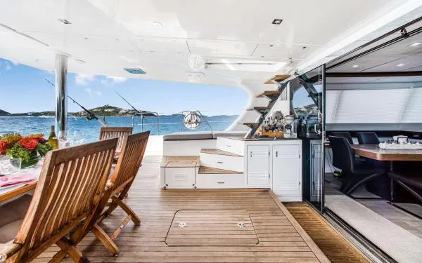 Euphoria Yacht Photos Pics Luxurious Sunreef 60 LOFT yacht interior with dining area, ocean view, and elegant wooden furnishings.