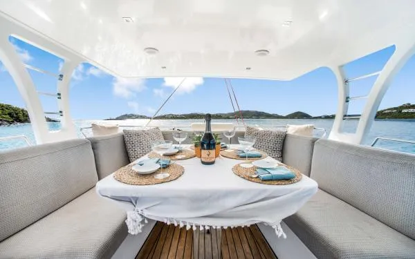 Euphoria Yacht Photos Pics Luxurious Sunreef 60 LOFT yacht dining area with elegant table setting, ocean view, 2016 model.