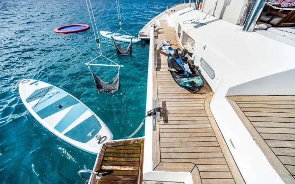 Euphoria Yacht Photos Pics Luxurious Sunreef 60 LOFT yacht deck with paddleboards and water activities, 2016 model.