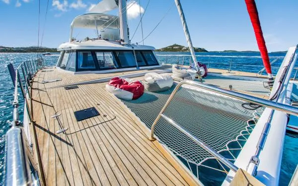 Euphoria Yacht Photos Pics Luxurious 2016 Sunreef 60 LOFT catamaran sailing on clear blue waters.