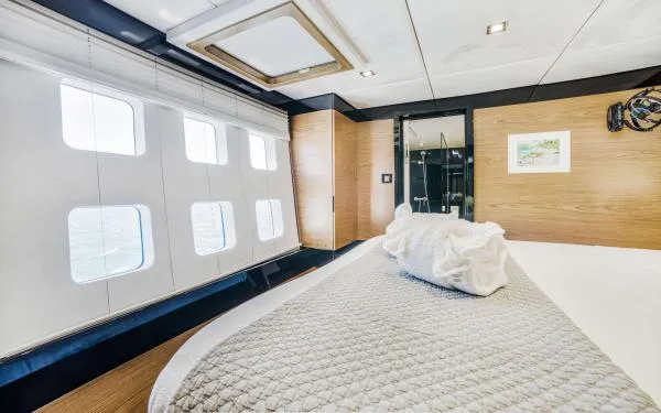 Euphoria Yacht Photos Pics Luxurious Sunreef 60 LOFT 2016 yacht bedroom with large windows and modern decor.