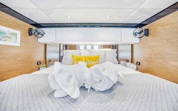 Euphoria Yacht Photos Pics Luxurious Sunreef 60 LOFT 2016 yacht bedroom with elegant decor and plush bedding.