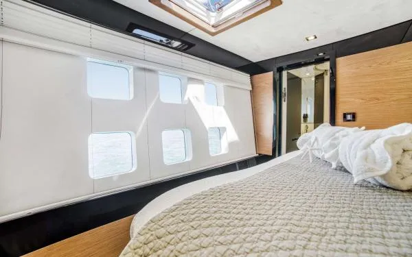 Euphoria Yacht Photos Pics Luxurious Sunreef 60 LOFT 2016 yacht interior with modern bedroom and large windows.