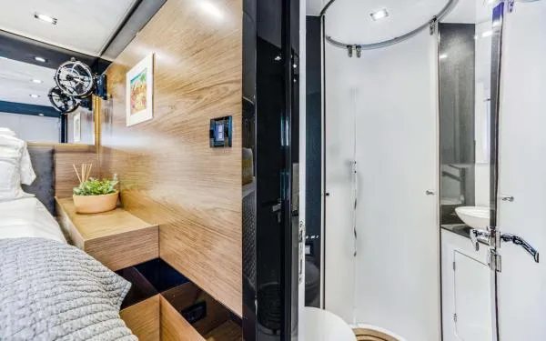 Euphoria Yacht Photos Pics Luxurious interior of 2016 Sunreef 60 LOFT yacht featuring modern bedroom and bathroom.