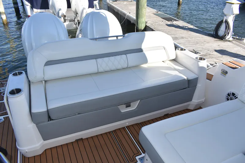  Yacht Photos Pics 2024 Regal 36 XO boat with cushioned seating and twin outboard engines at dock.