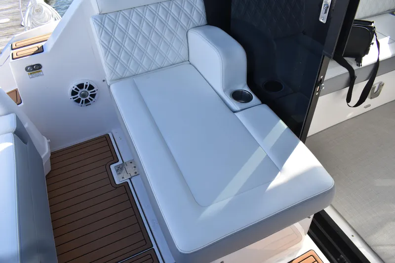  Yacht Photos Pics 2024 Regal 36 XO boat interior with white cushioned seating and cup holder.