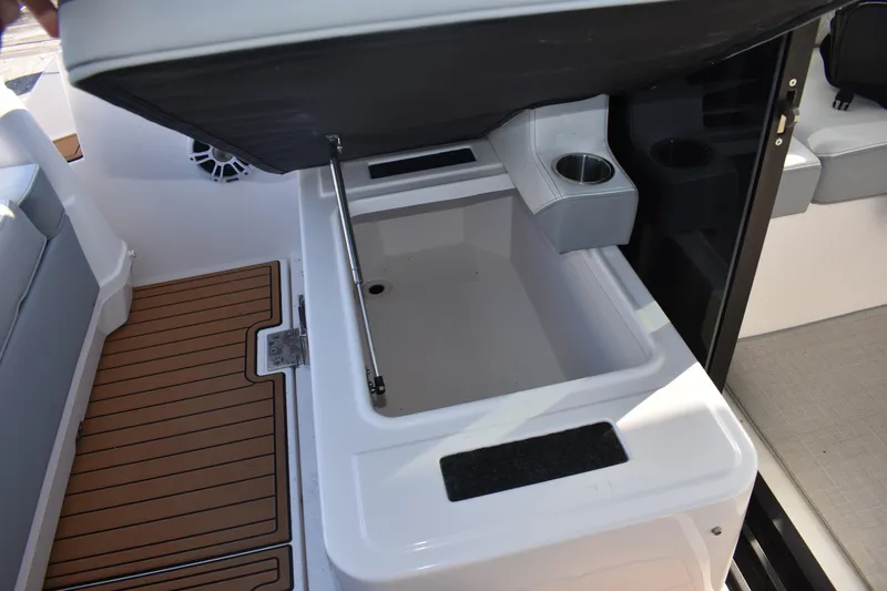  Yacht Photos Pics 2024 Regal 36 XO boat interior storage compartment with cup holders and teak flooring.