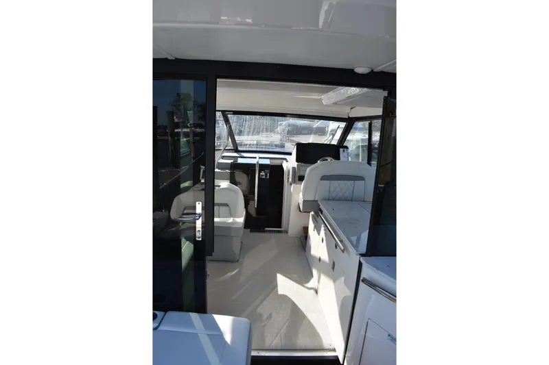  Yacht Photos Pics Interior view of 2024 Regal 36 XO yacht, showcasing modern seating and helm area.