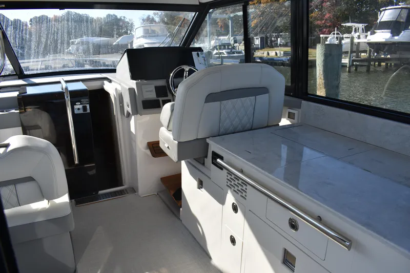  Yacht Photos Pics Interior of 2024 Regal 36 XO boat with helm, seating, and sleek design.