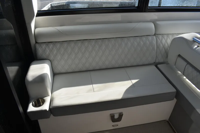  Yacht Photos Pics 2024 Regal 36 XO boat interior with luxurious white leather seating and cup holder.