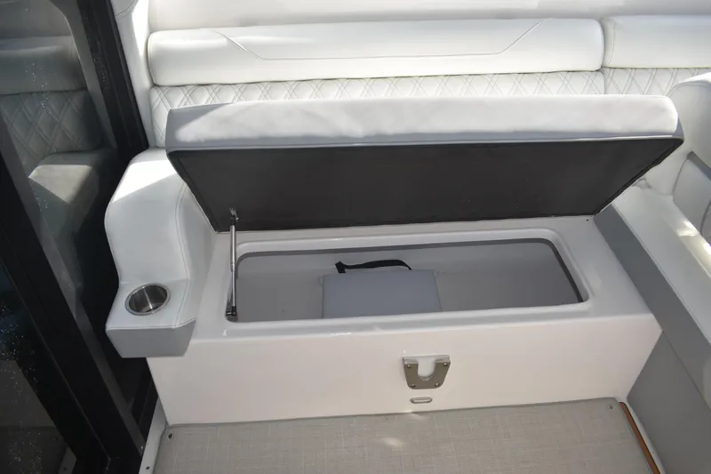  Yacht Photos Pics 2024 Regal 36 XO boat interior with open storage compartment and cup holder.