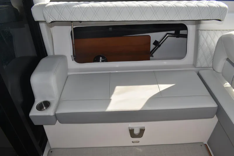  Yacht Photos Pics 2024 Regal 36 XO boat interior with white cushioned seating and cup holder.