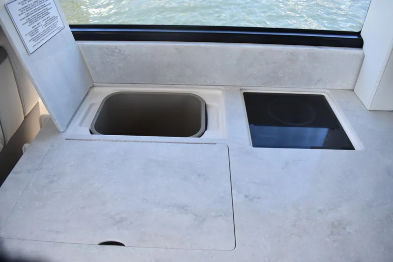  Yacht Photos Pics 2024 Regal 36 XO yacht kitchen countertop with sink and stove.