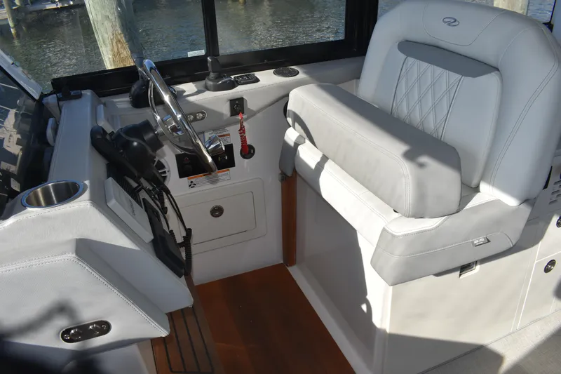  Yacht Photos Pics 2024 Regal 36 XO boat helm with luxurious seating and modern controls.