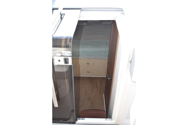  Yacht Photos Pics 2024 Regal 36 XO cabin interior with wooden flooring and storage drawers.