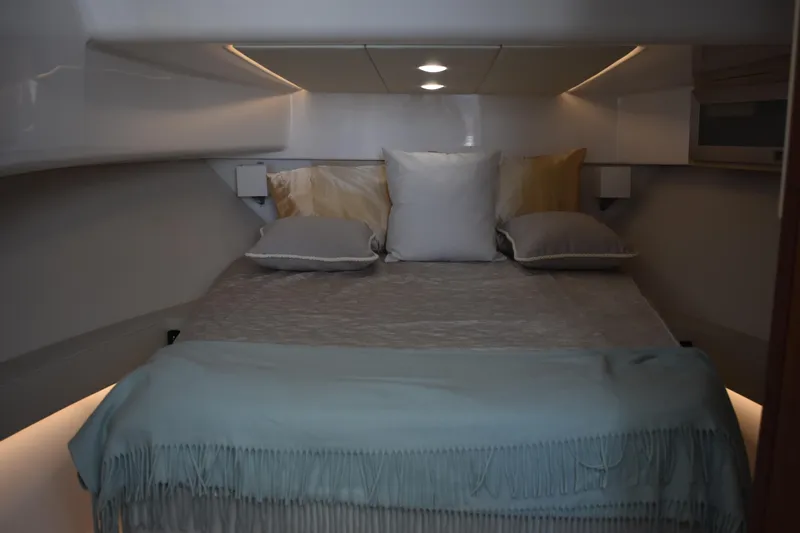  Yacht Photos Pics Luxurious cabin interior of 2024 Regal 36 XO yacht with cozy bedding.