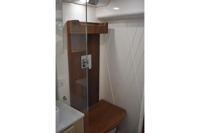  Yacht Photos Pics 2024 Regal 36 XO yacht bathroom with modern shower design and wooden accents.