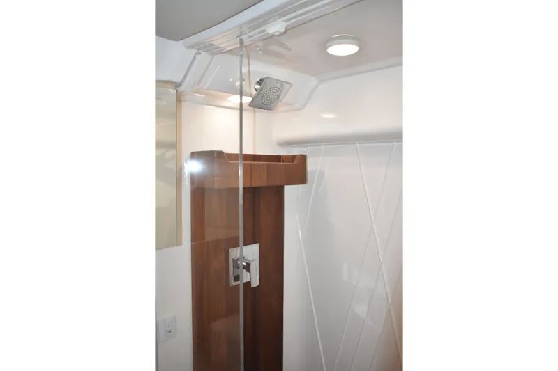  Yacht Photos Pics 2024 Regal 36 XO yacht shower with modern fixtures and wooden accents.
