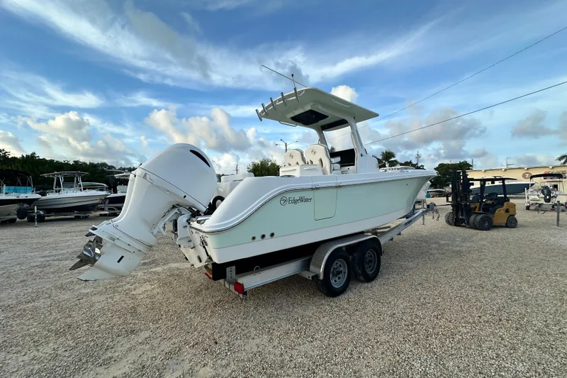  Yacht Photos Pics 2021 Edgewater 262CC boat on trailer, parked outdoors under a blue sky.
