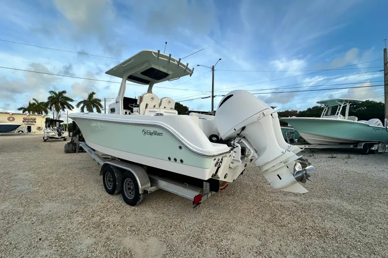  Yacht Photos Pics 2021 Edgewater 262CC boat on trailer, parked outdoors under a blue sky.