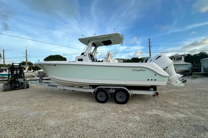  Yacht Photos Pics 2021 Edgewater 262CC boat on trailer, parked outdoors under a blue sky.