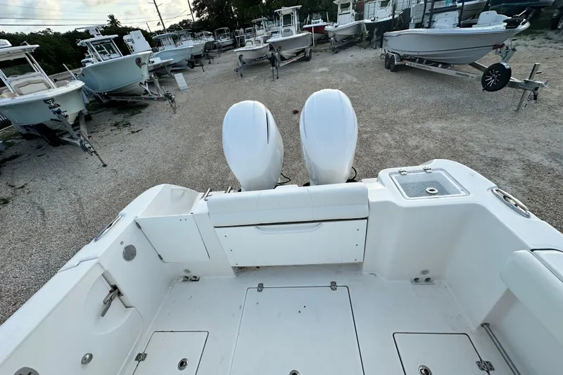  Yacht Photos Pics 2021 Edgewater 262CC boat with dual engines in a boatyard setting.