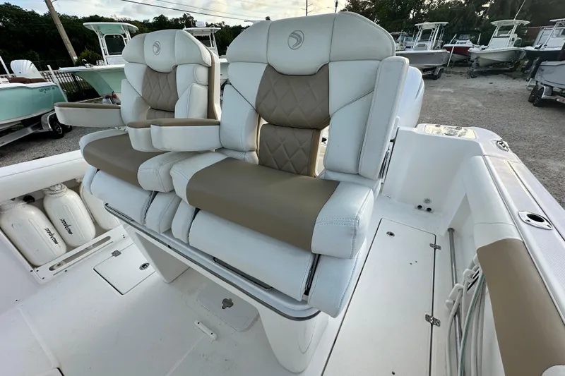  Yacht Photos Pics Luxury seating on 2021 Edgewater 262CC boat, featuring plush, dual captain's chairs.