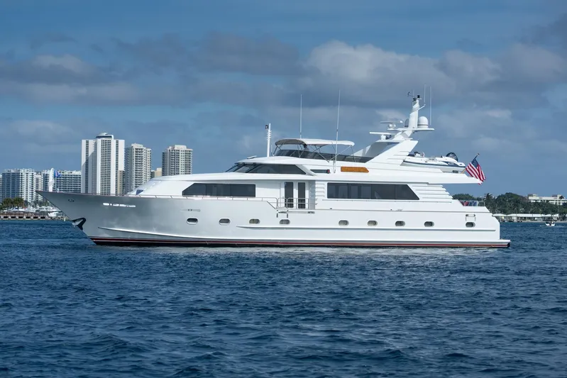 Crown Jewel Yacht Photos Pics Luxury 1996 Broward 96 Raised Pilothouse yacht cruising near city skyline.
