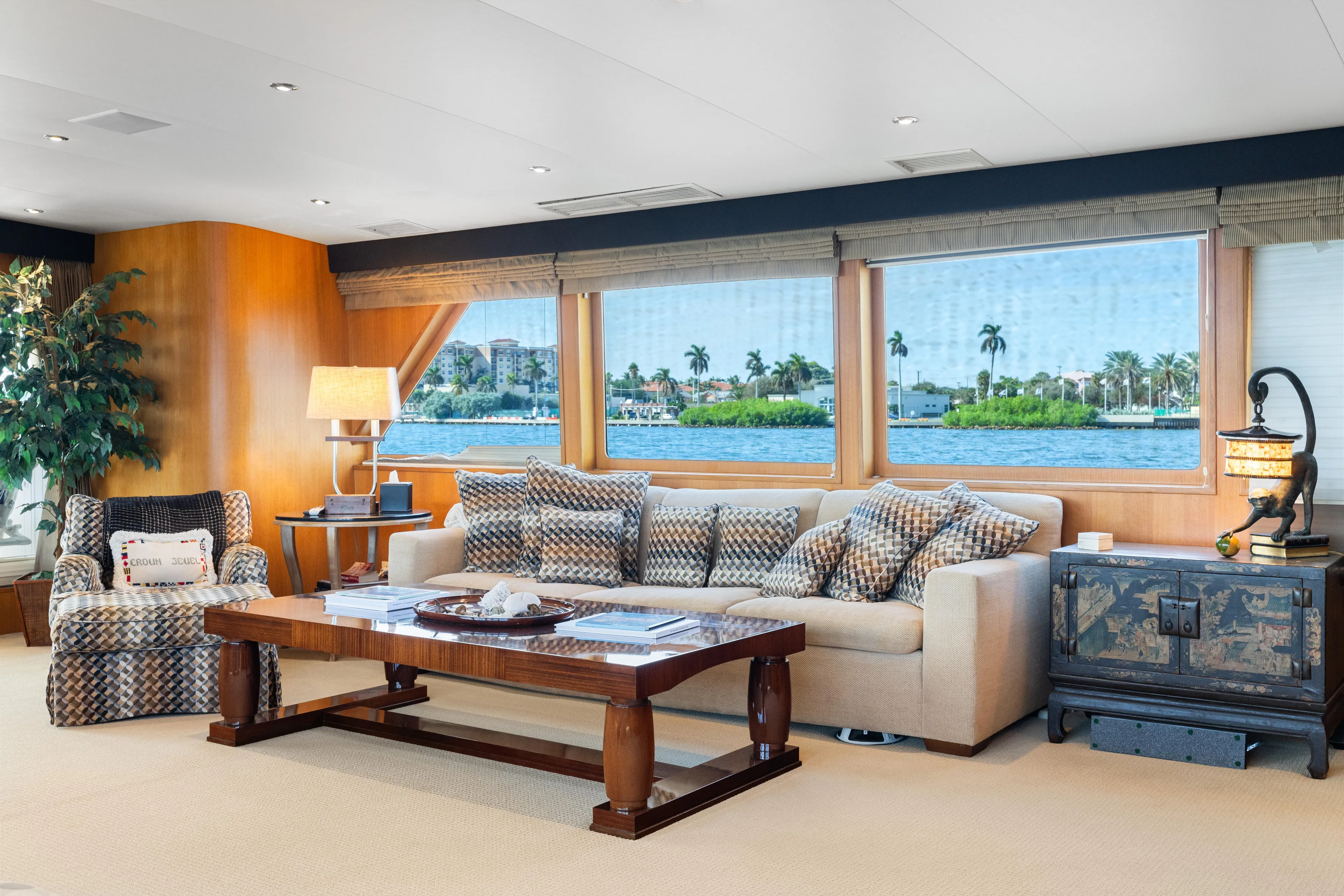 Crown Jewel Yacht Photos Pics Luxurious yacht interior with plush seating, large windows, and elegant decor on a 1996 Broward model.