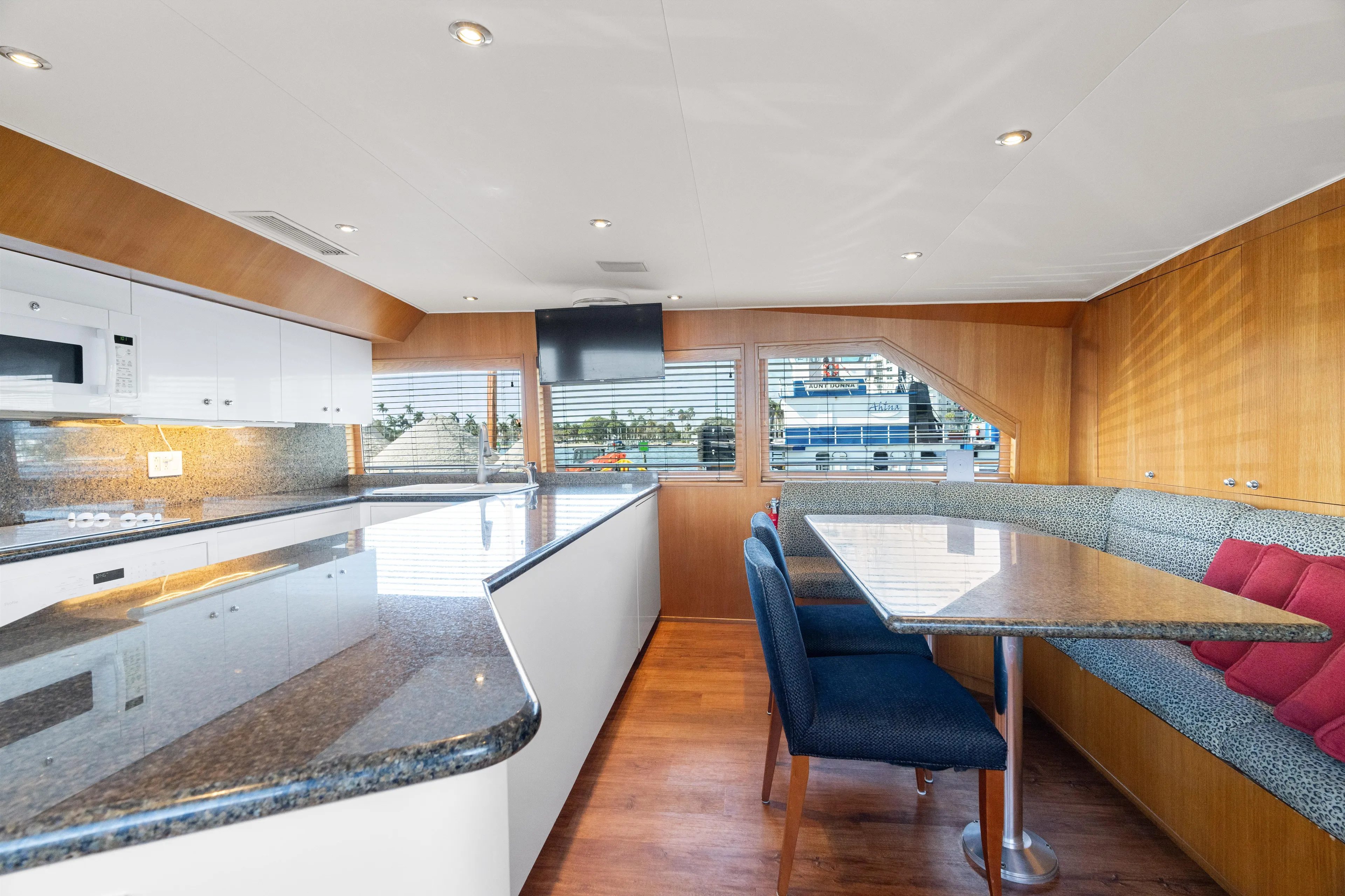 Crown Jewel Yacht Photos Pics Luxurious kitchen and dining area in 1996 Broward 96 Raised Pilothouse MY yacht.